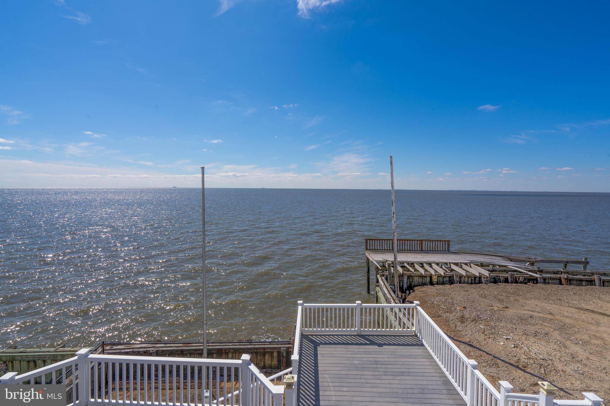 98 Delaware Avenue Fortescue, NJ 08321 - Photo 2 of 51 a view of roof deck with two chairs and wooden fence