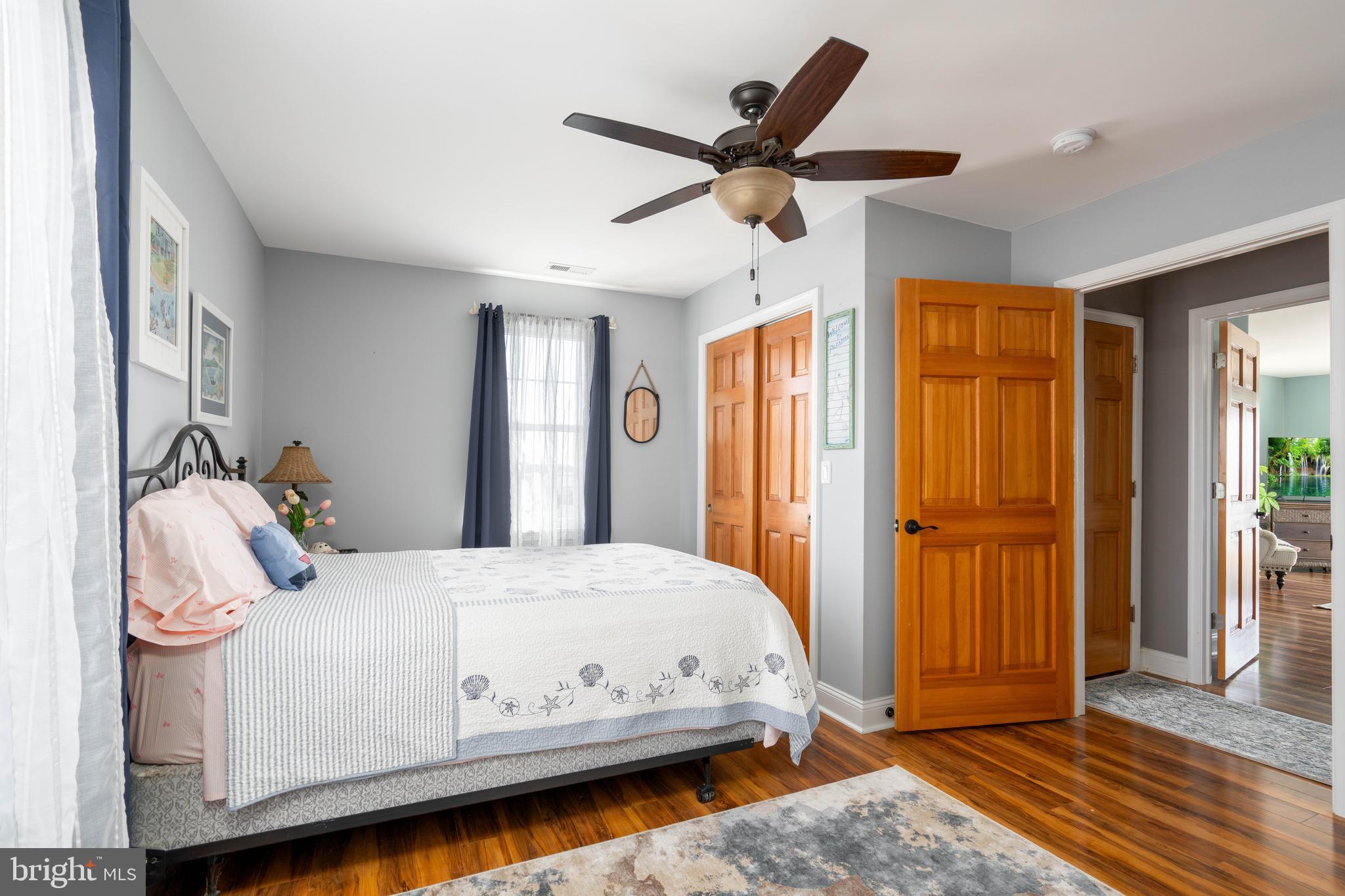 98 Delaware Avenue Fortescue, NJ 08321 - Photo 21 of 51 a bedroom with a large bed and a chandelier