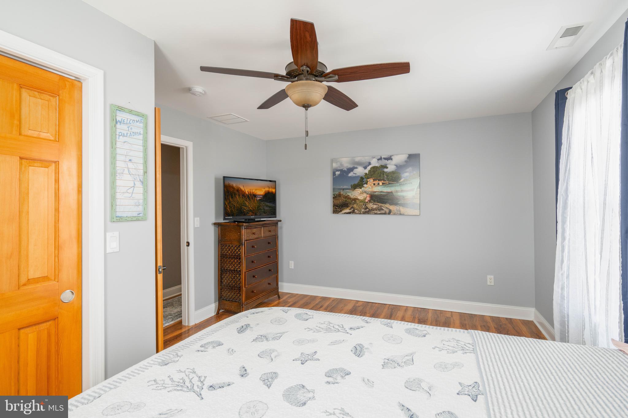 98 Delaware Avenue Fortescue, NJ 08321 - Photo 22 of 51 a bedroom with a bed and a chandelier