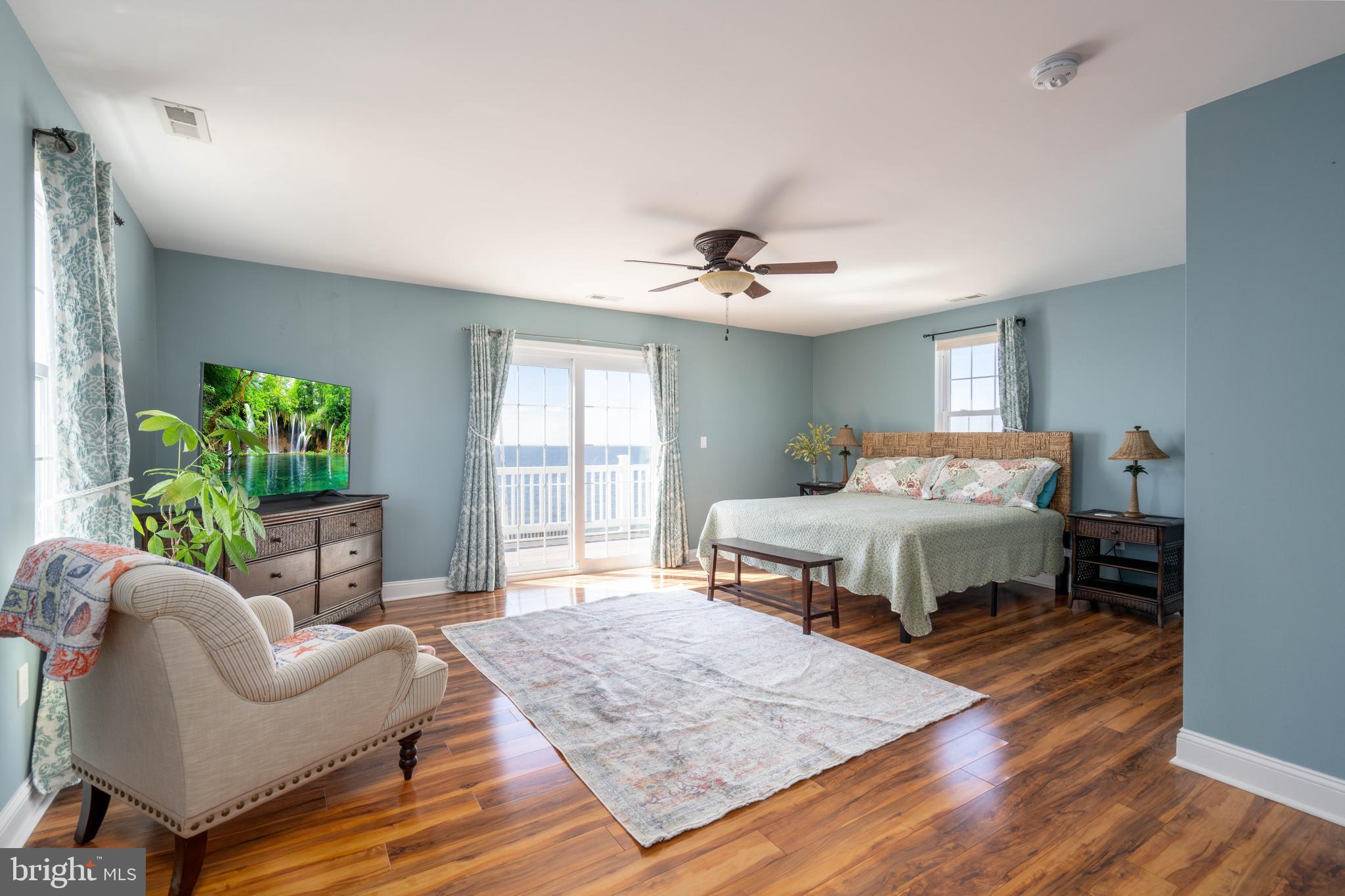98 Delaware Avenue Fortescue, NJ 08321 - Photo 23 of 51 a bedroom with a bed a chandelier and dresser