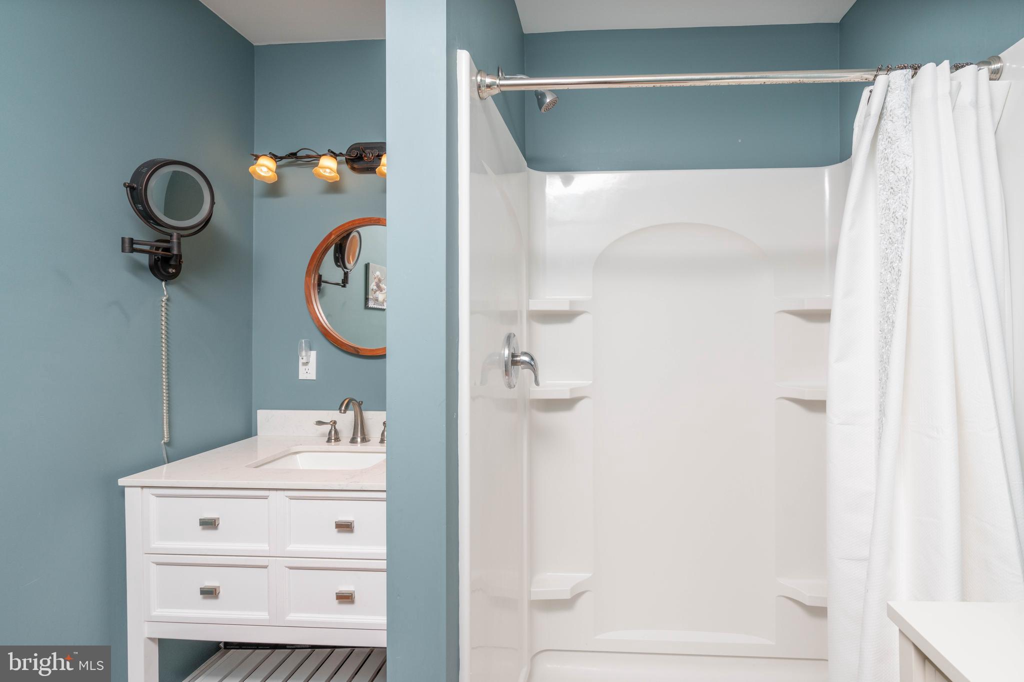 98 Delaware Avenue Fortescue, NJ 08321 - Photo 27 of 51 a bathroom with a mirror and a shower