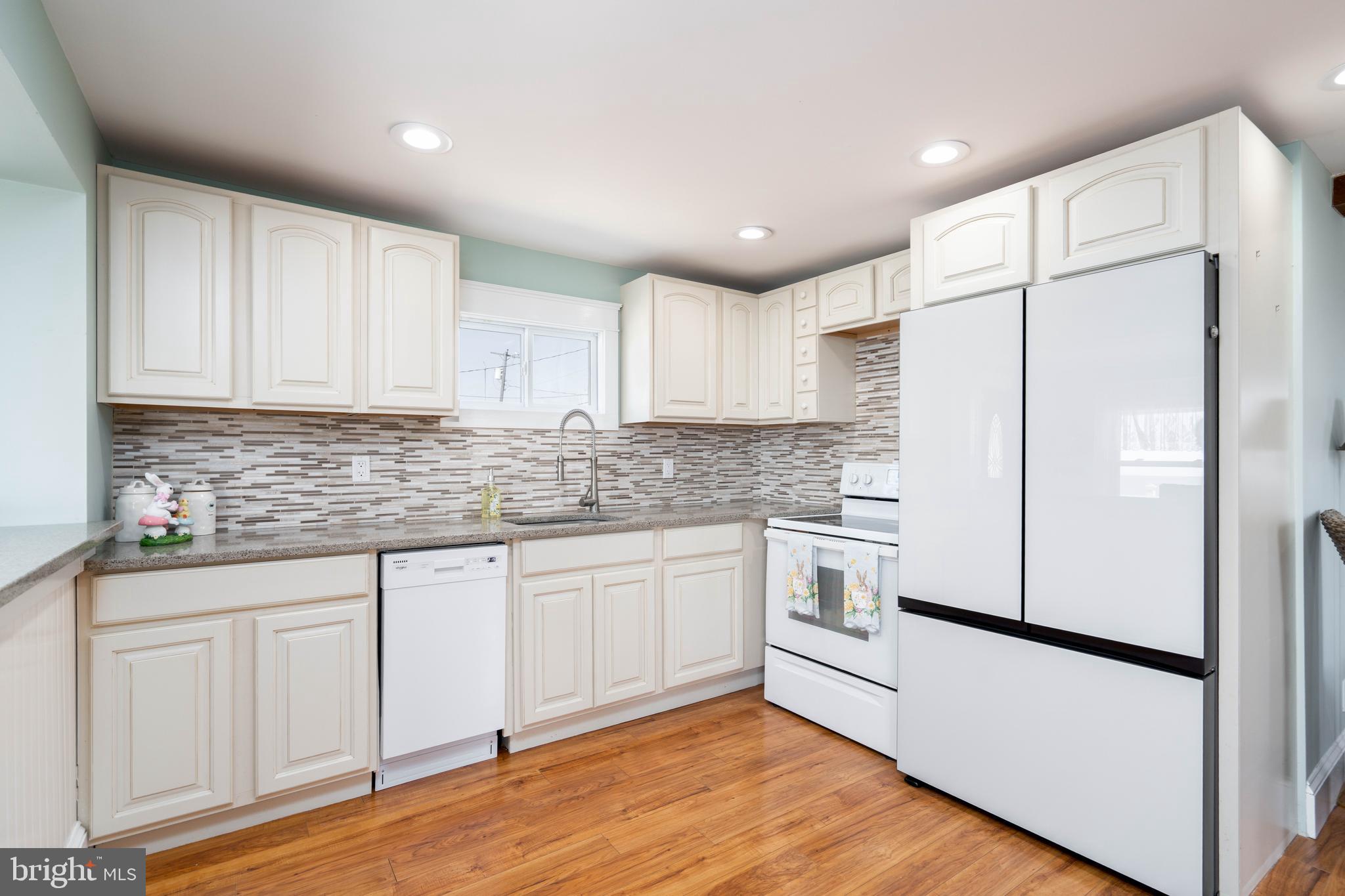 98 Delaware Avenue Fortescue, NJ 08321 - Photo 8 of 51 a kitchen with granite countertop white cabinets and white appliances