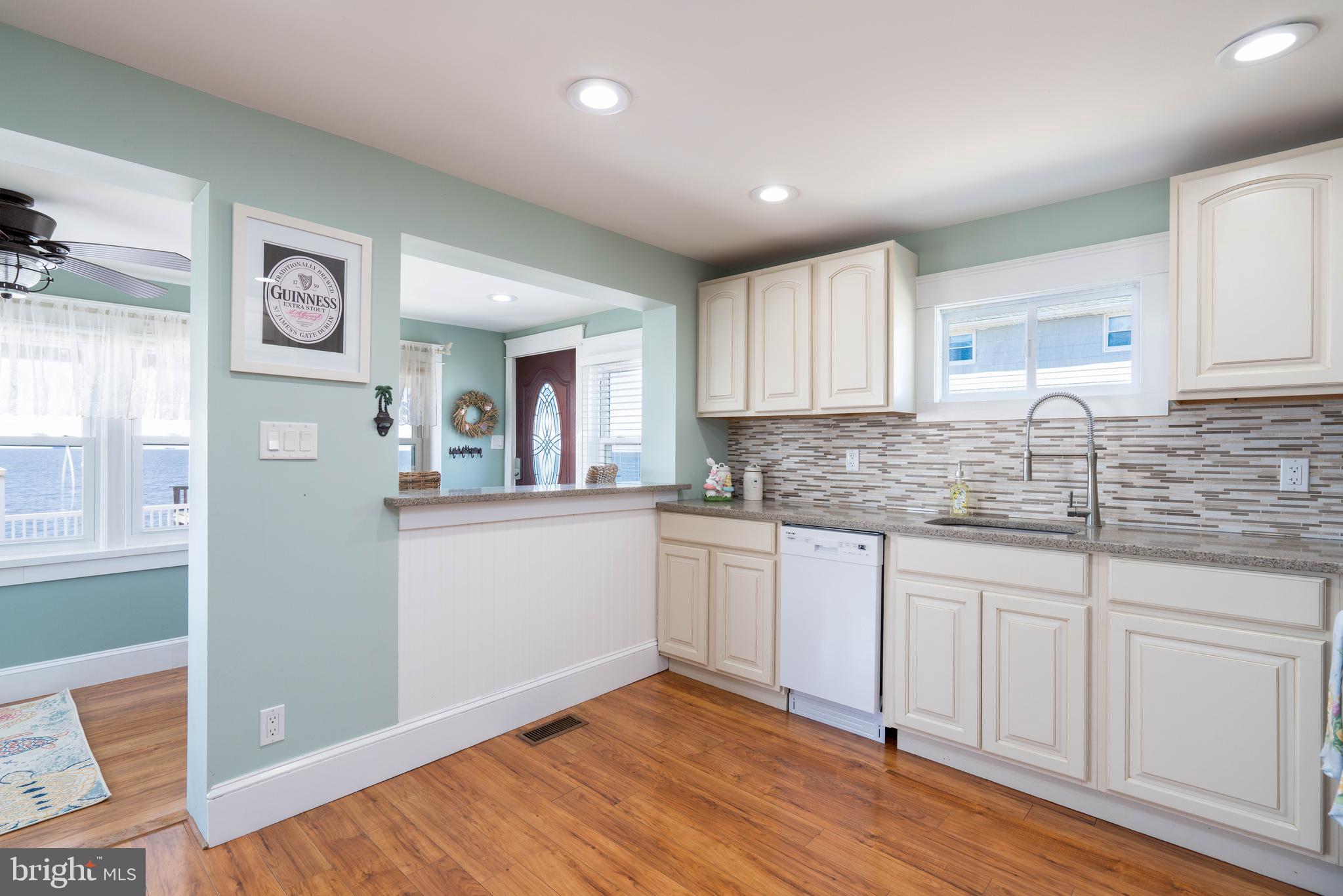 98 Delaware Avenue Fortescue, NJ 08321 - Photo 9 of 51 a kitchen with granite countertop white cabinets and white appliances