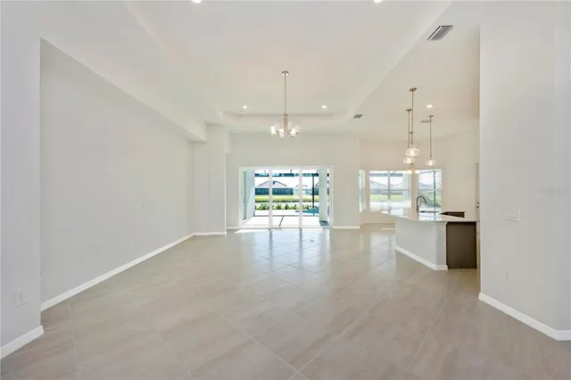 a large kitchen with stainless steel appliances lots of counter space and a sink