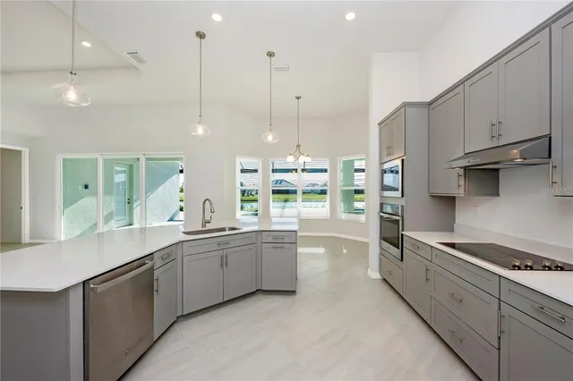 an empty room with a window and a ceiling fan