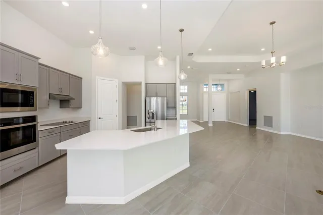 a view of an empty room and a ceiling fan