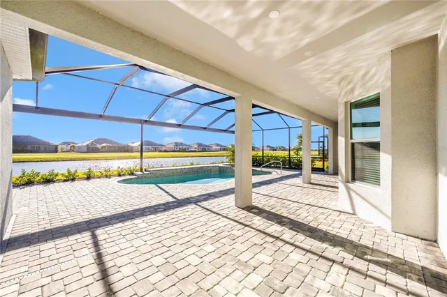 a view of a patio with a table and chairs