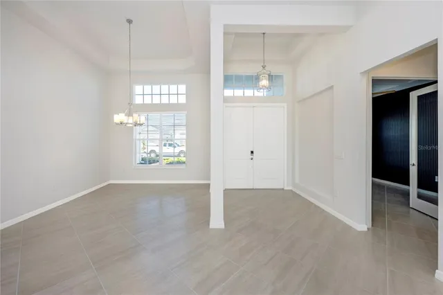 a view of an empty room with window and cabinet