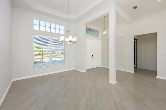 a view of a kitchen with refrigerator and wooden floor