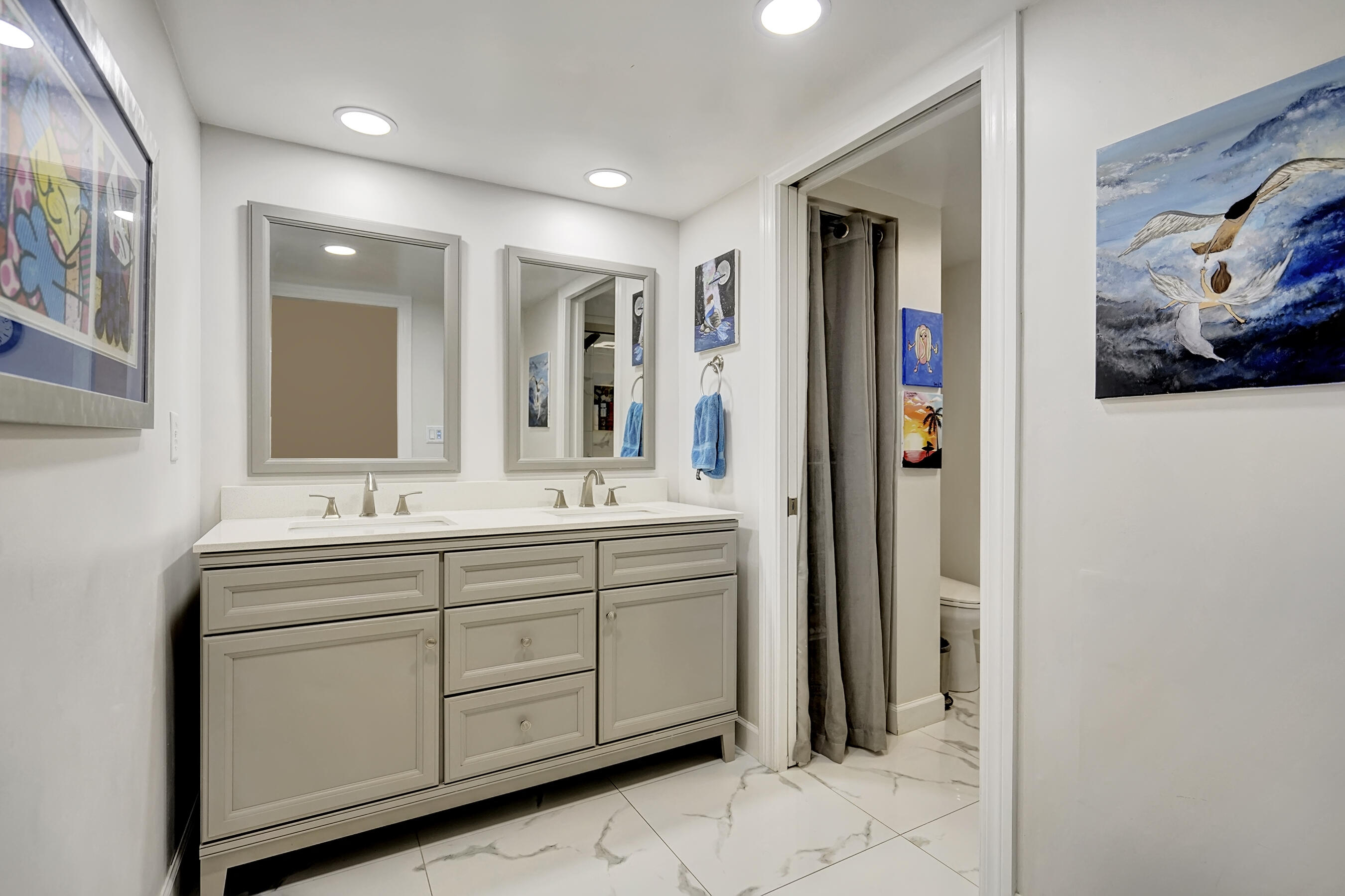 22176 Boca Rancho Drive, Unit C Boca Raton, FL 33428 - Photo 13 of 34 a bathroom with a double vanity sink and a mirror