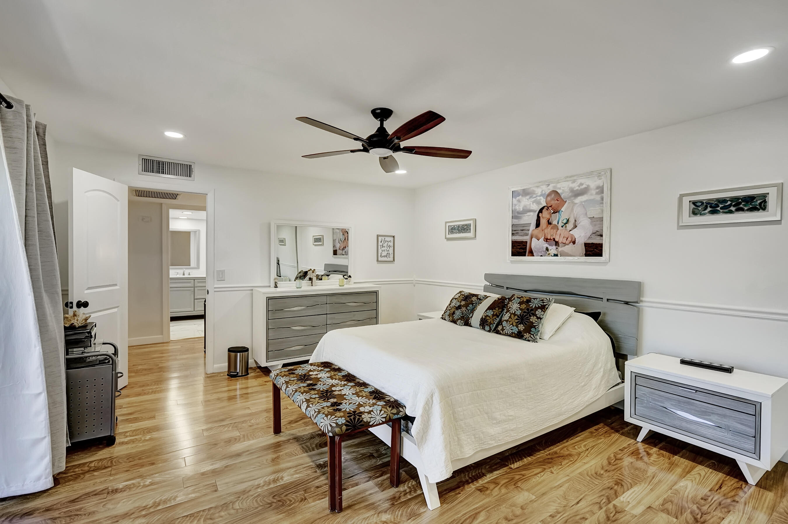 22176 Boca Rancho Drive, Unit C Boca Raton, FL 33428 - Photo 15 of 34 a bedroom with a bed and a chandelier