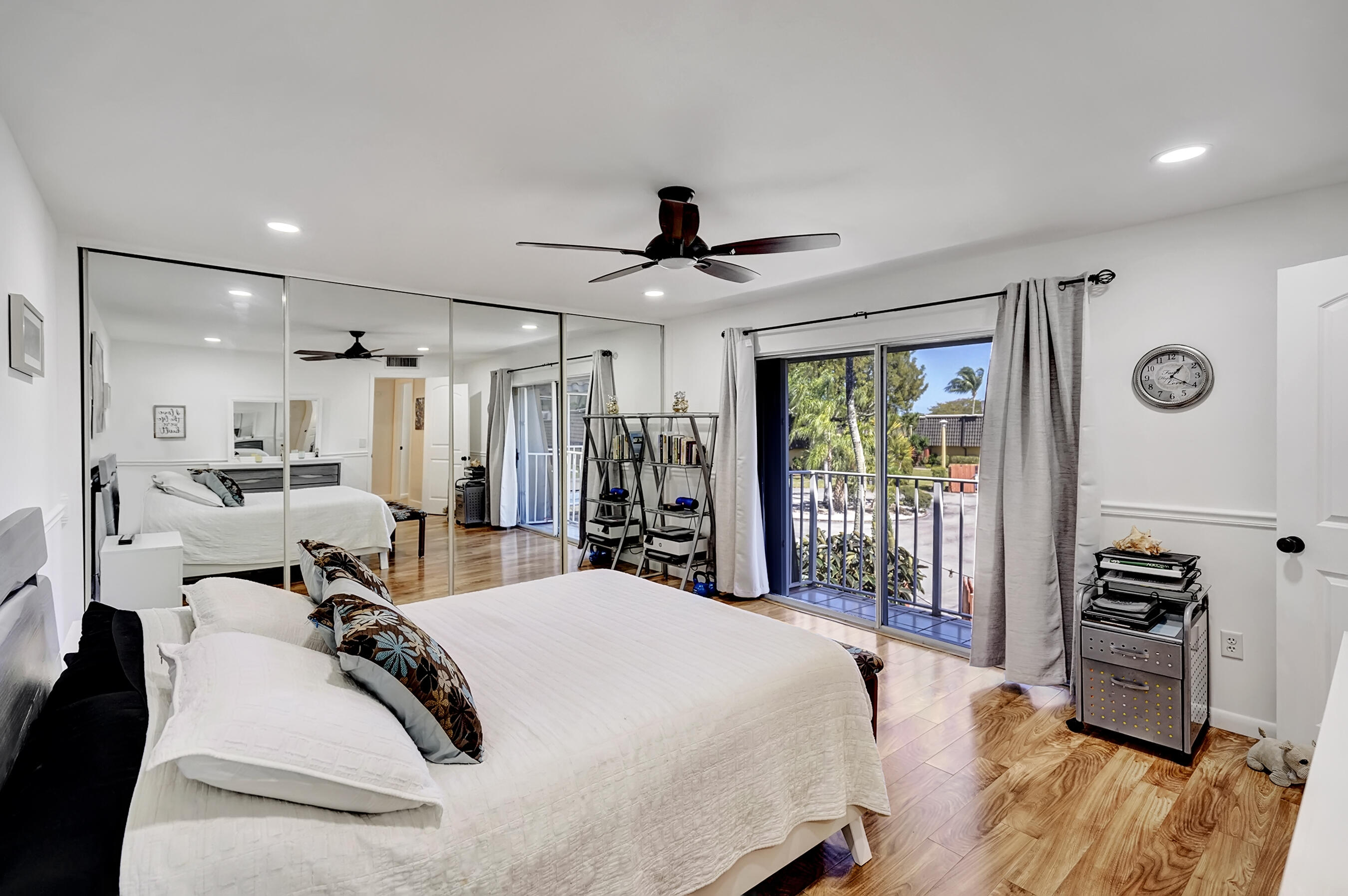22176 Boca Rancho Drive, Unit C Boca Raton, FL 33428 - Photo 17 of 34 a bed room with a bed and a chandelier