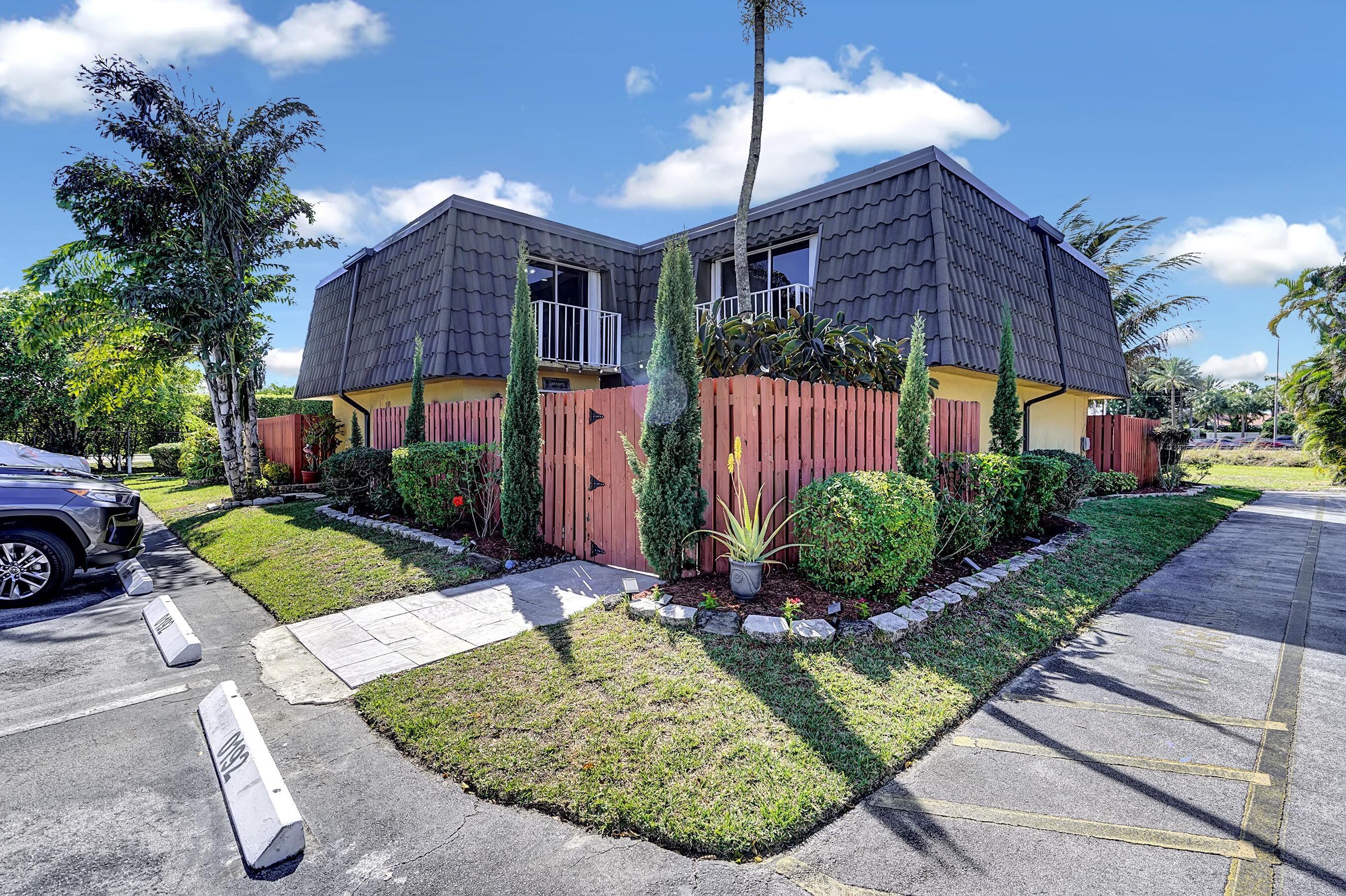 22176 Boca Rancho Drive, Unit C Boca Raton, FL 33428 - Photo 25 of 34 a view of a house with a yard fire pit and potted plants