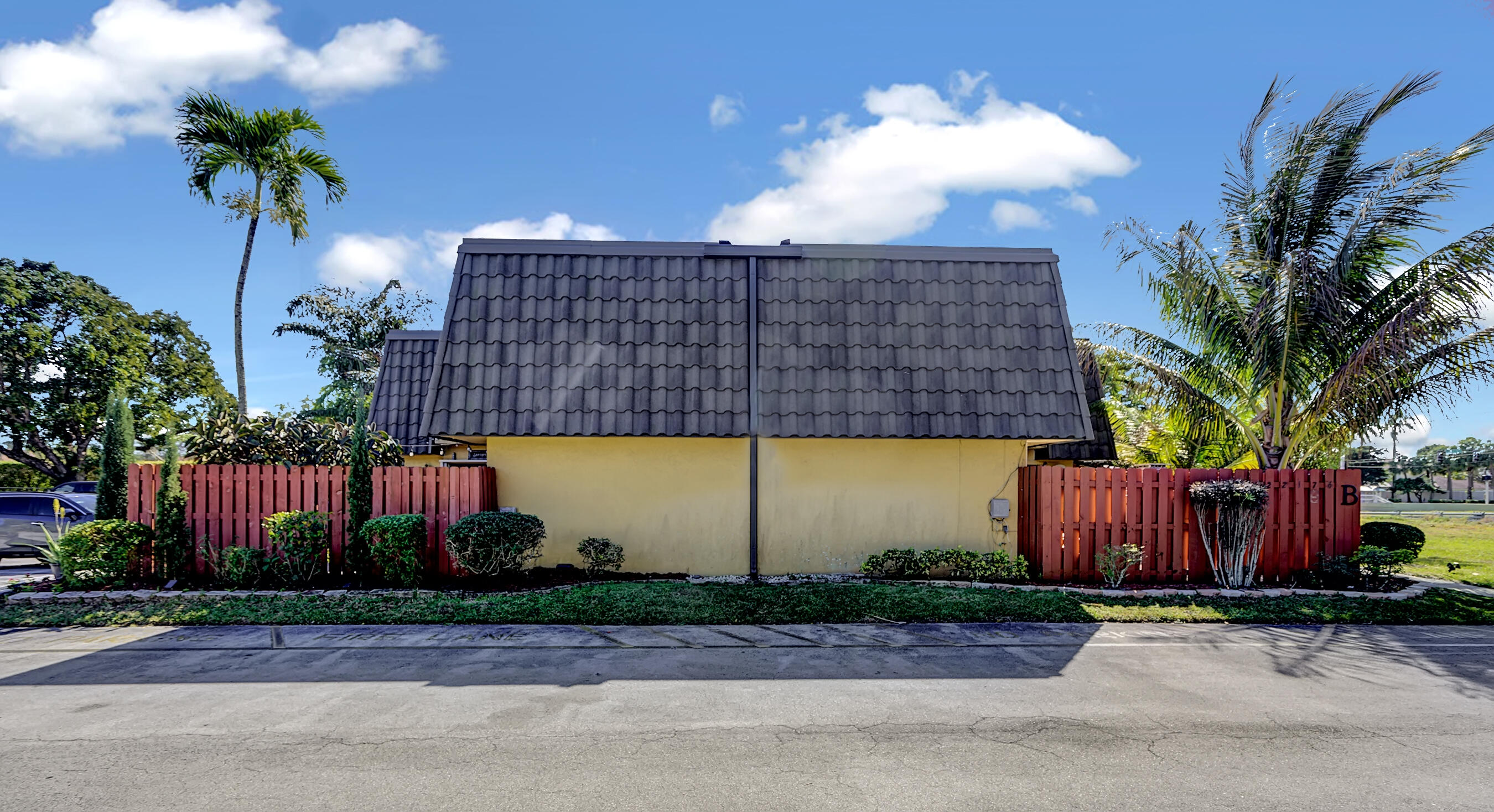 22176 Boca Rancho Drive, Unit C Boca Raton, FL 33428 - Photo 29 of 34 a front view of a house with garden
