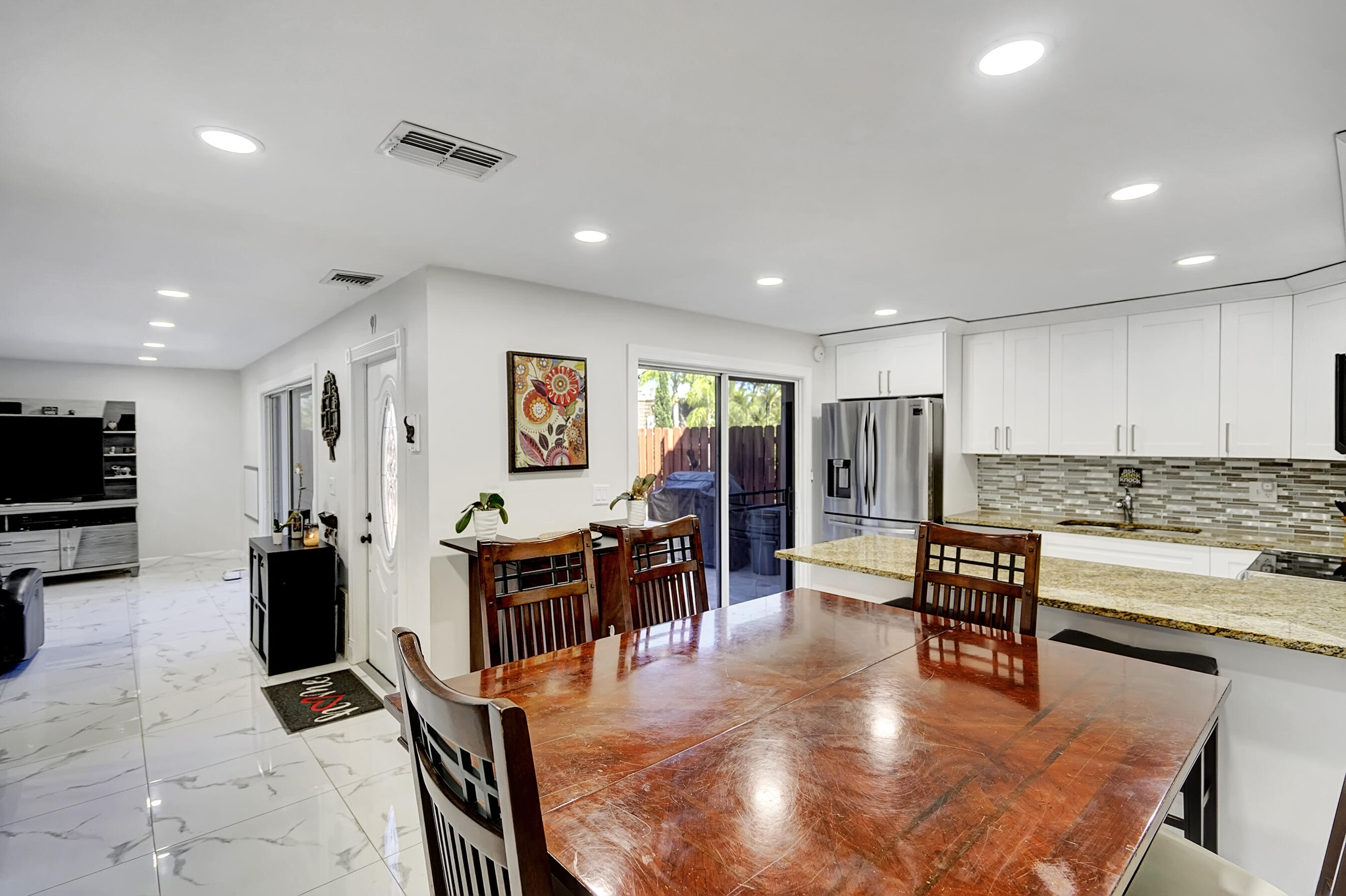 22176 Boca Rancho Drive, Unit C Boca Raton, FL 33428 - Photo 5 of 34 a living room with lots of furniture and kitchen view