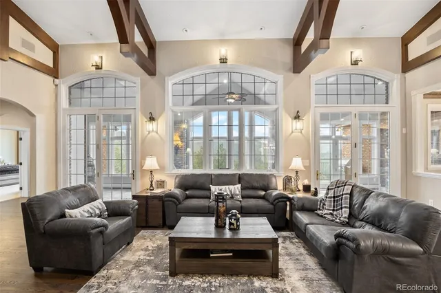 a living room with furniture ceiling fan and a rug