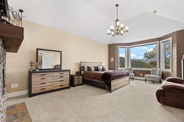 a living room with furniture chandelier and a flat screen tv
