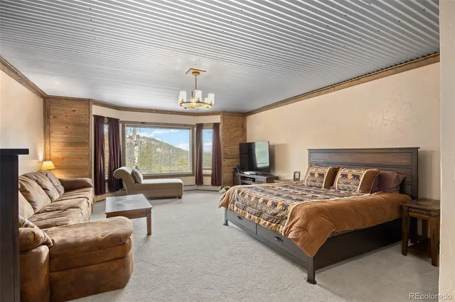 a bedroom with a bed and glass windows