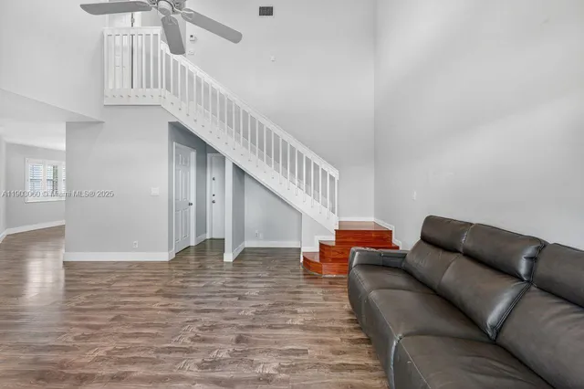 a living room with furniture and stairs