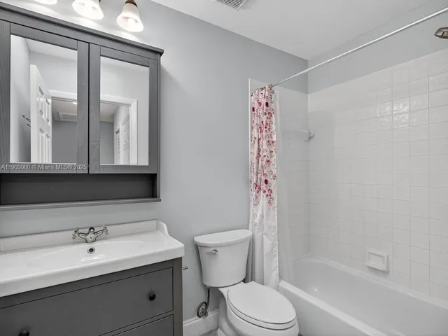 a bathroom with a bath tub with a shower