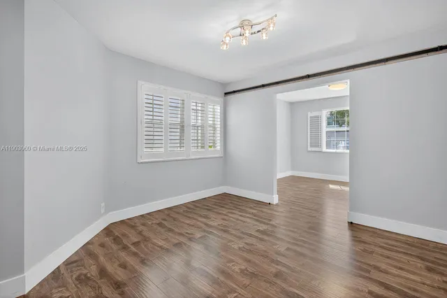 wooden floor in an empty room with a window