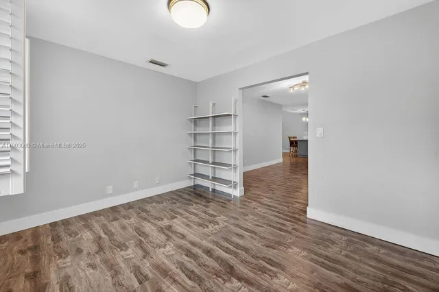 a view of a room with wooden floor and closet