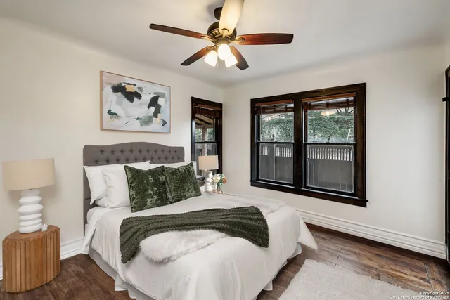 a bedroom with a bed and a large window