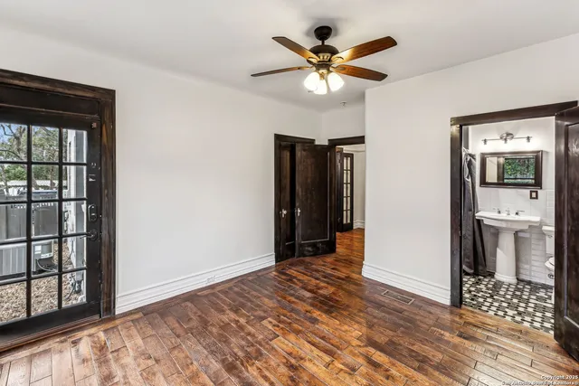 a view of a hallway with wooden floor and a large window