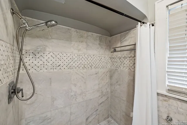 a bathroom with a glass shower door