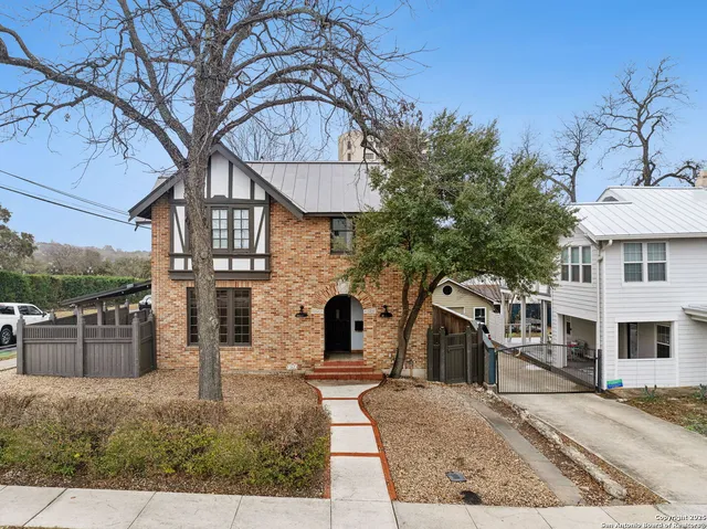 a view of a white house with a sink and yard