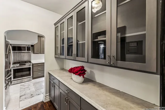 a kitchen with stainless steel appliances granite countertop a stove and cabinets