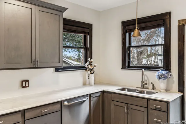 a kitchen with a sink cabinets and window