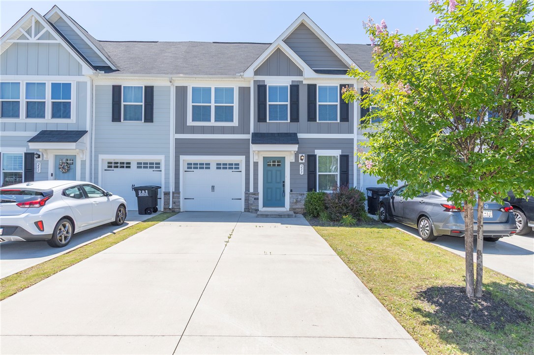 233 Scenic Road Anderson, SC 29621 - Photo 2 of 50 A welcoming front entry with vibrant blue door, flanked by tidy landscaping and a spacious concrete driveway.