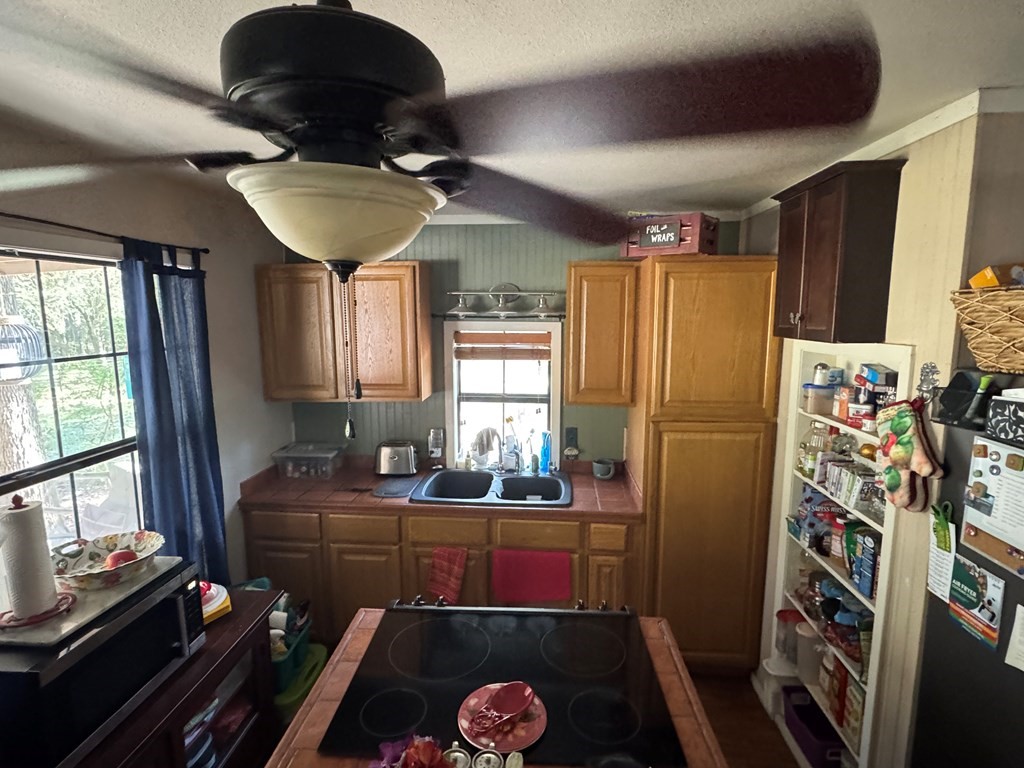 690 Jim Fenley Loop Lufkin, TX 75901 - Photo 21 of 22 a kitchen with stainless steel appliances a refrigerator a stove a sink and a dining table