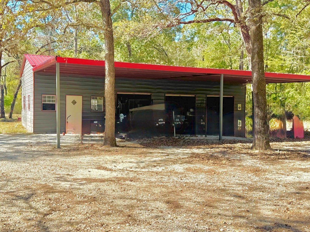 690 Jim Fenley Loop Lufkin, TX 75901 - Photo 7 of 22 a view of a house with a yard and tree s