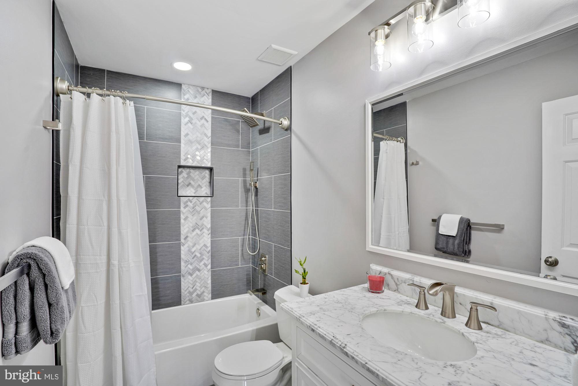 8915 Spur Road Springfield, VA 22153 - Photo 18 of 35 Hall Bath with tub, Marble tile and counter.