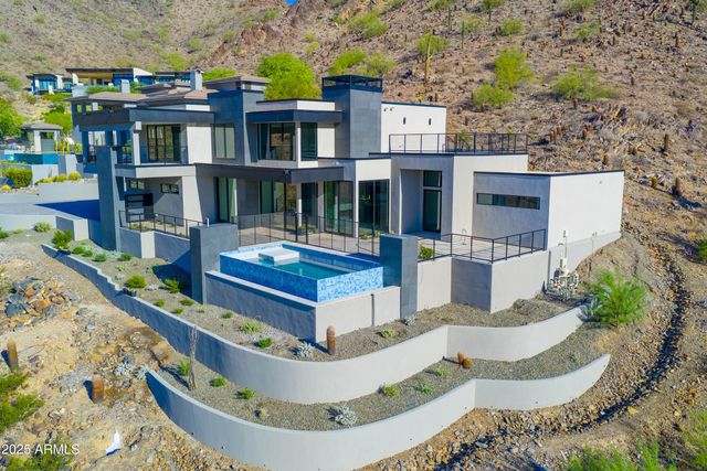 a swimming pool with outdoor seating and plants