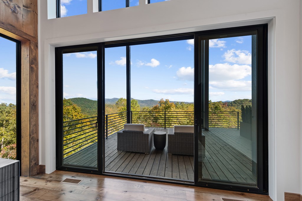 321 Skylight Drive Blue Ridge, GA 30513 - Photo 45 of 89 a view of a balcony with floor to ceiling windows with wooden floor