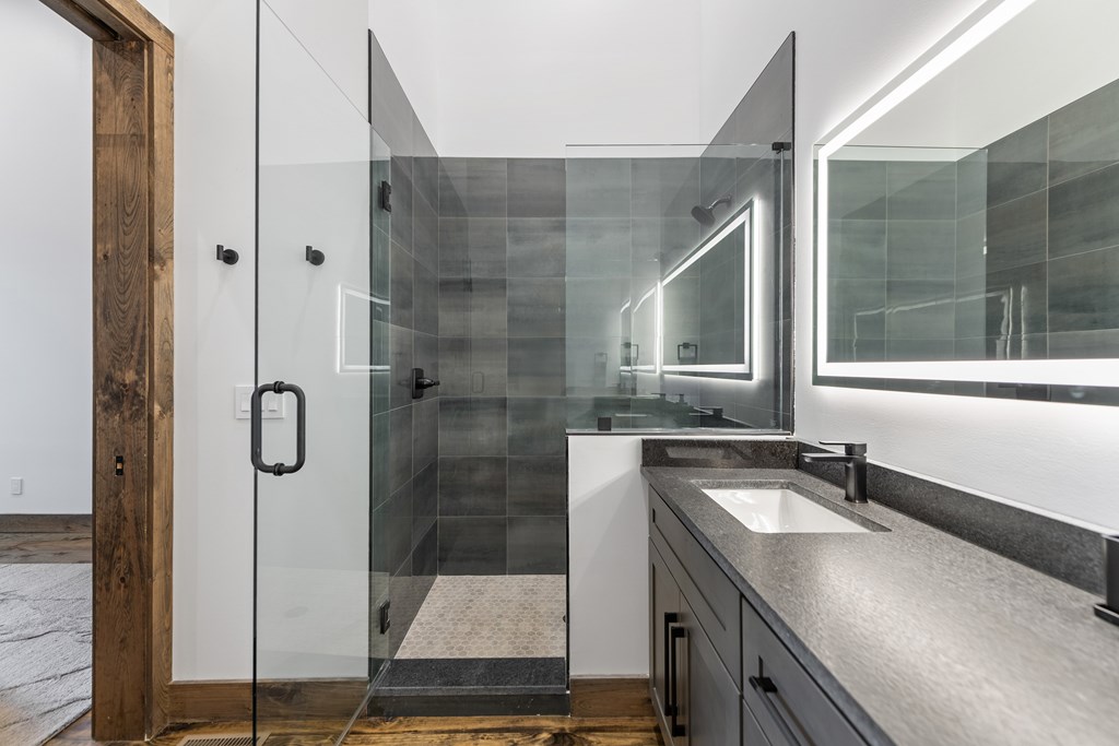 321 Skylight Drive Blue Ridge, GA 30513 - Photo 67 of 89 a bathroom with a shower sink and mirror