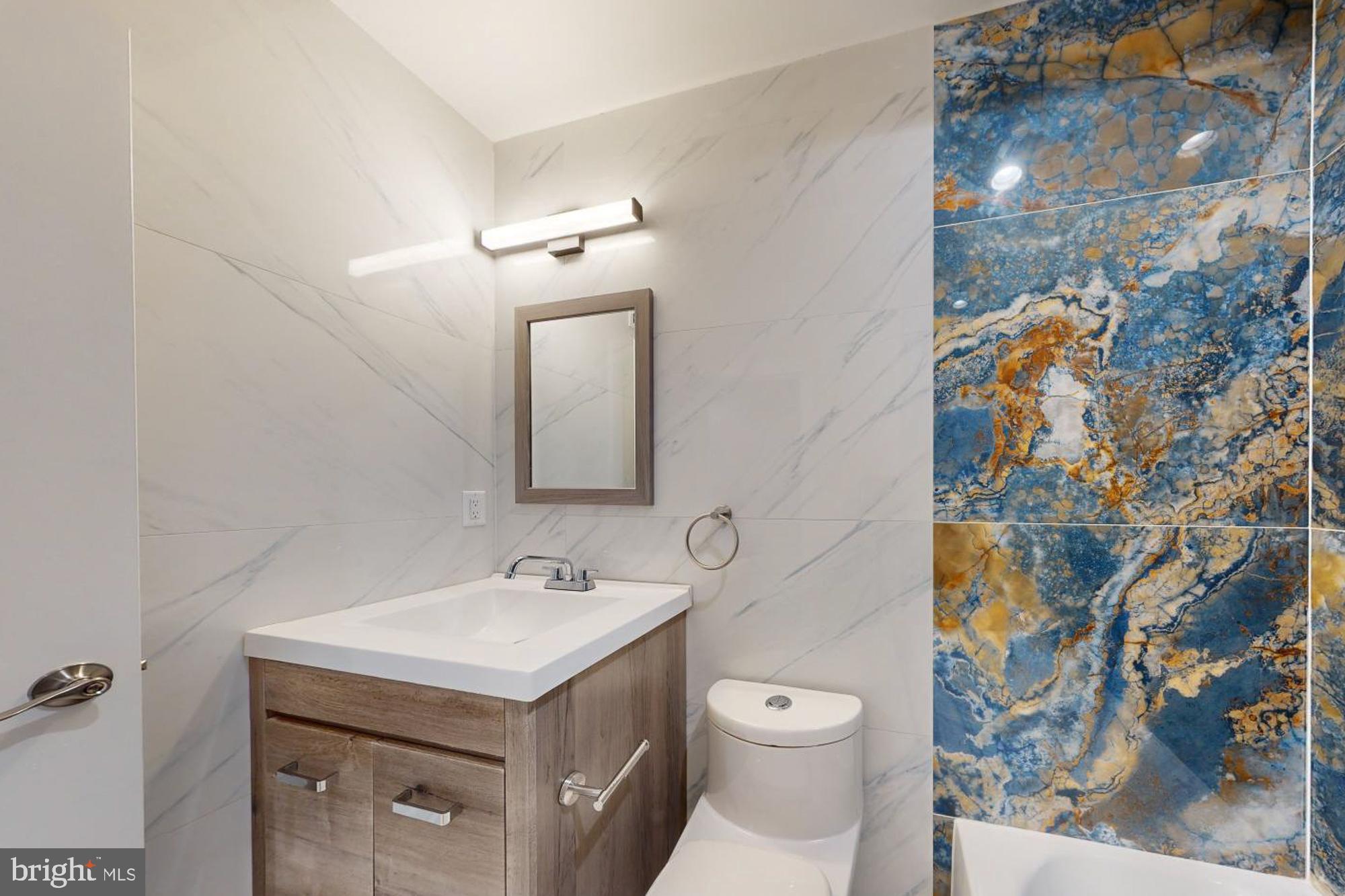 511 North Paxon Street Philadelphia, PA 19131 - Photo 15 of 33 a bathroom with a sink and a mirror