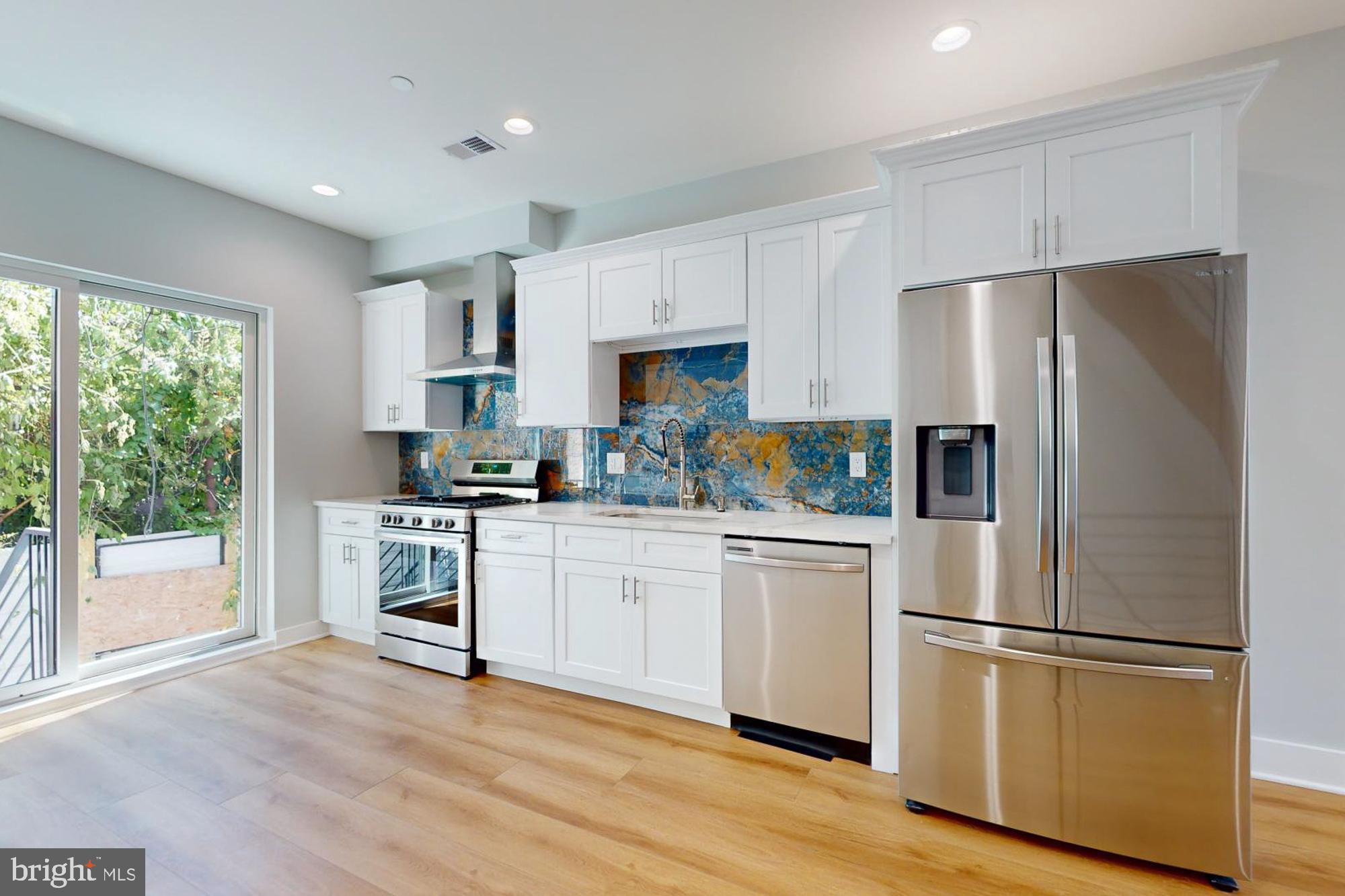 511 North Paxon Street Philadelphia, PA 19131 - Photo 5 of 33 a kitchen with stainless steel appliances a refrigerator sink and cabinets