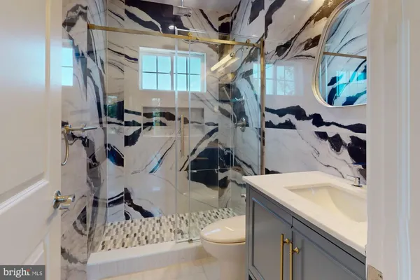 a bathroom with a sink a toilet and mirror