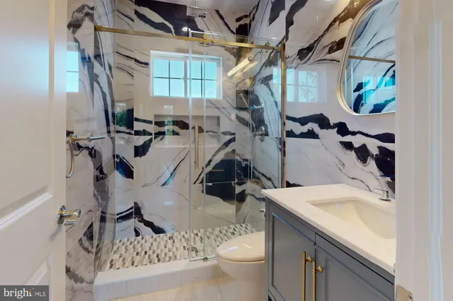 a bathroom with a sink a toilet and mirror