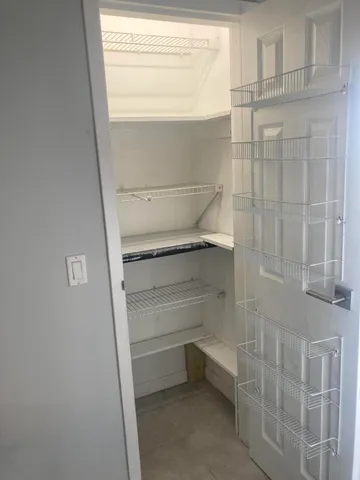 a view of kitchen with granite countertop cabinets and outdoor view