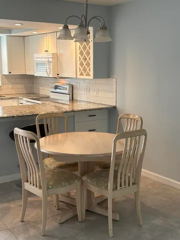a view of an empty room with furniture and a window