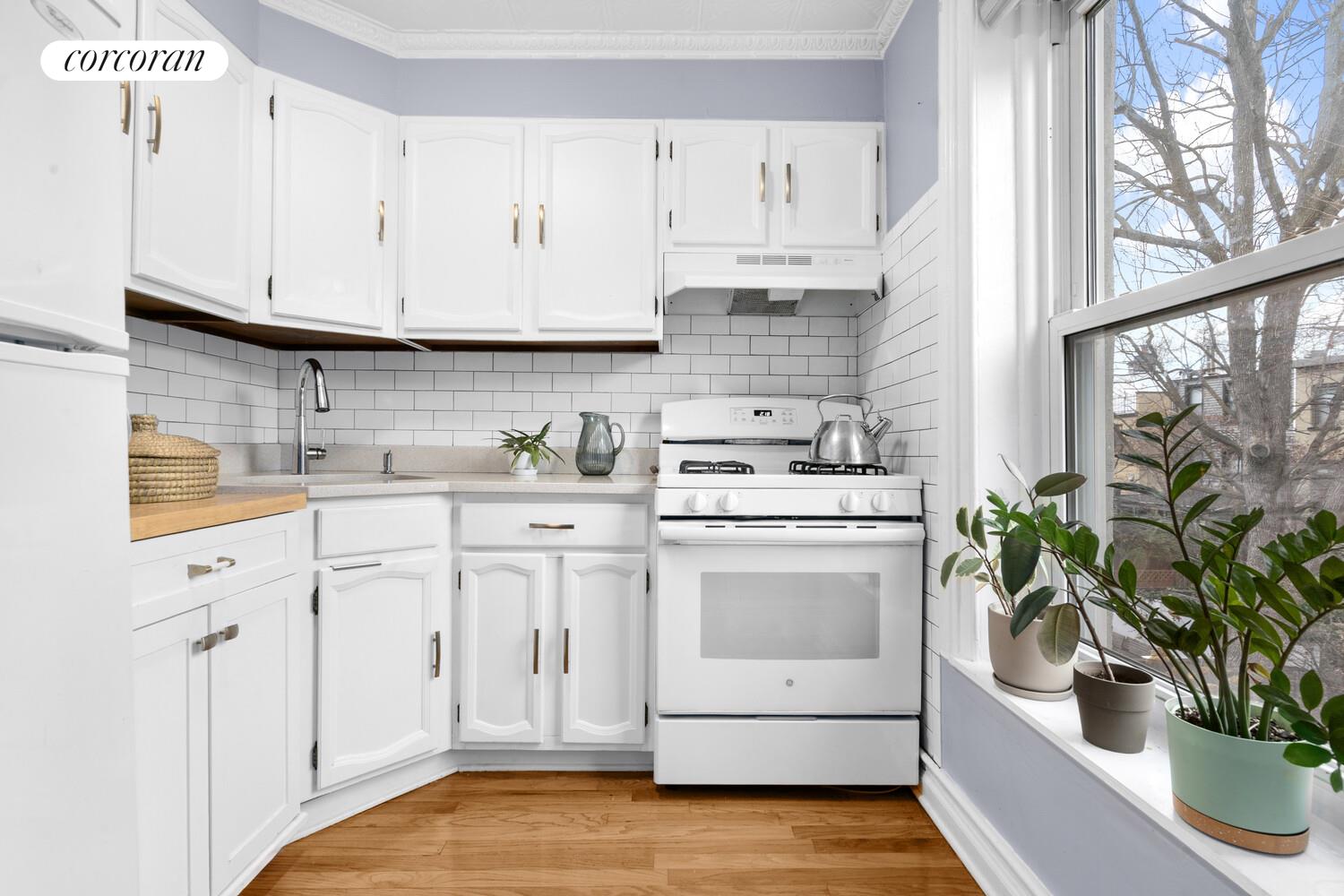 75 2nd Street Brooklyn, NY 11231 - Photo 5 of 14 a kitchen with white cabinets and white appliances