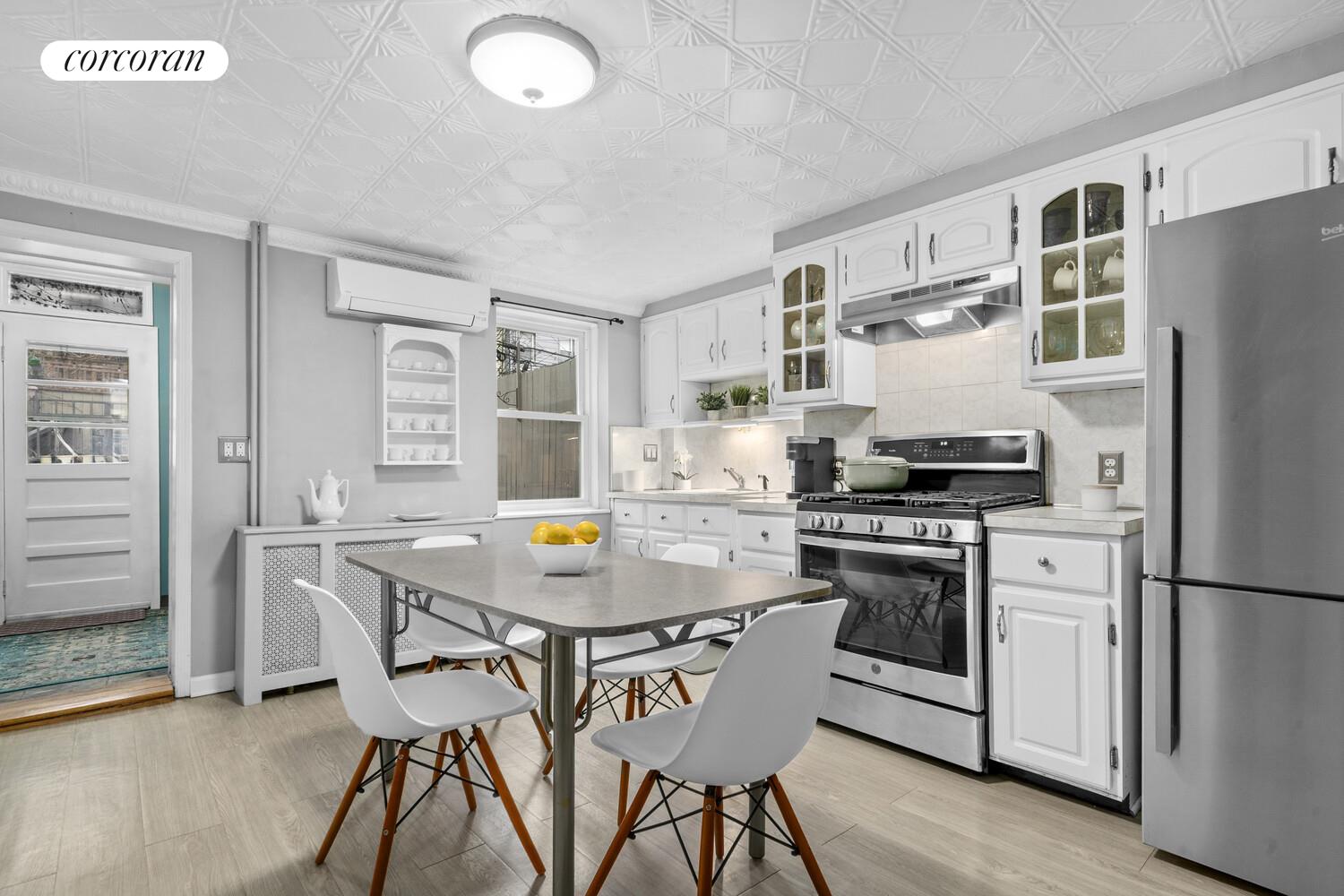 75 2nd Street Brooklyn, NY 11231 - Photo 9 of 14 a kitchen with stainless steel appliances a stove a sink dishwasher a refrigerator white cabinets and wooden floor