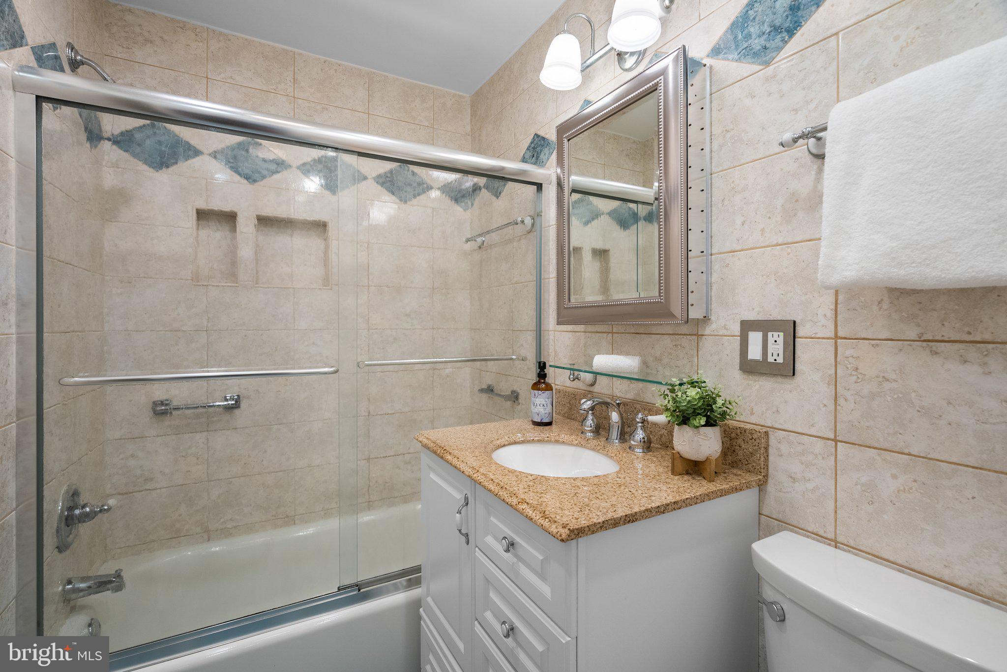 1007 Helena Drive Silver Spring, MD 20901 - Photo 19 of 39 a bathroom with a granite countertop shower sink vanity and mirror