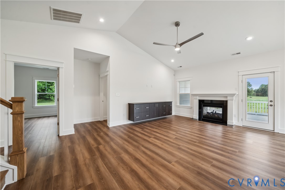 114 Logan Way Tappahannock, VA 22560 - Photo 15 of 28 an empty room with wooden floor fireplace and windows