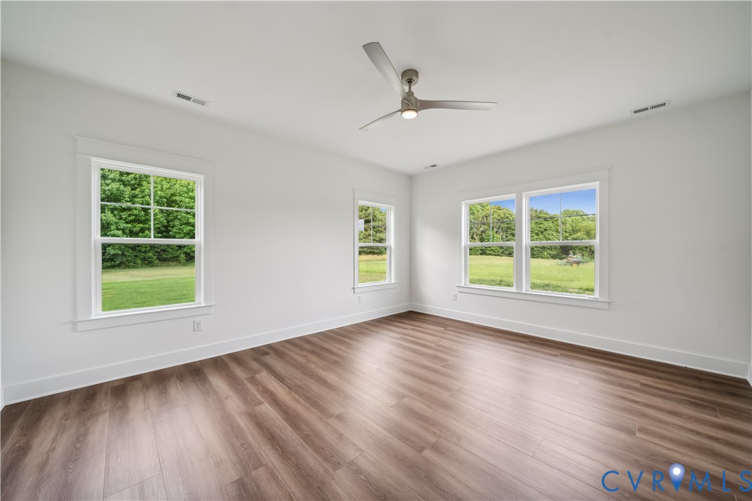 114 Logan Way Tappahannock, VA 22560 - Photo 16 of 28 a view of an empty room with wooden floor and a window